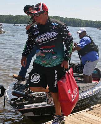<p>
	Chris Lane steps off his boat onto the dock to take his fish up to the scales.</p>
