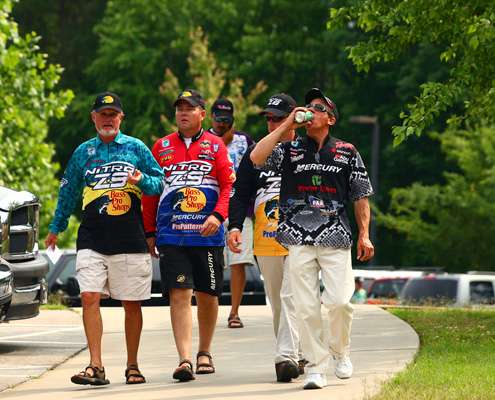 <p> 	A group of Elite Series anglers walk down a path to the meeting for the Evan Williams Bourbon Carolina Clash.</p> 
