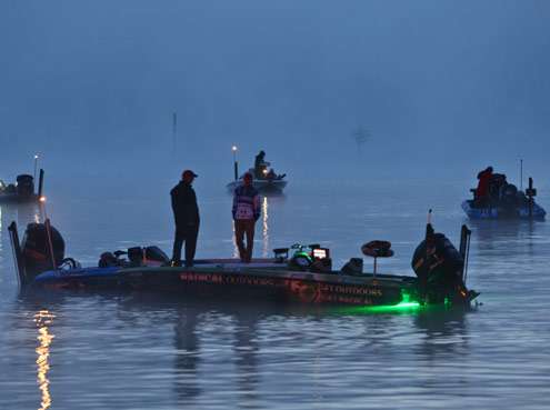 <p>
	A few boats wait to hear whether the fog would delay the launch on Friday.</p>
