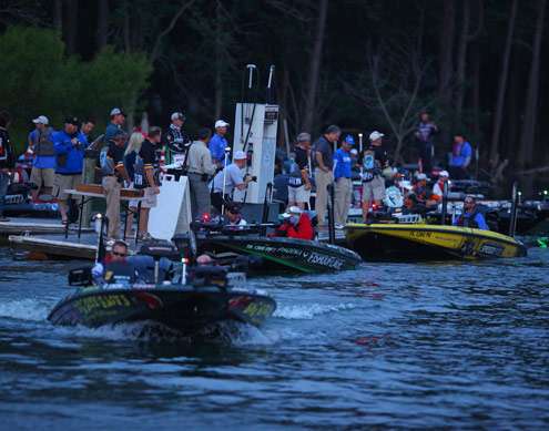<p>
	A line of boats idle away from the dock to start the second day of competition.</p>

