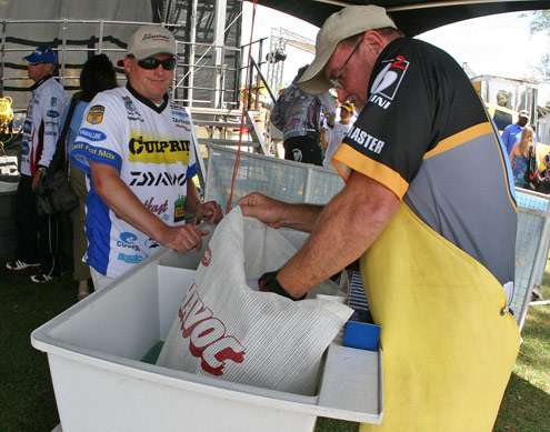 <p>
	Dustin Wilks looks on as a B.A.S.S. official bumps his Day Two catch.</p>
