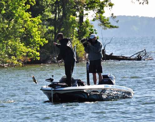 <p>
	The bass gets swung into the boat as a camera films the action.</p>

