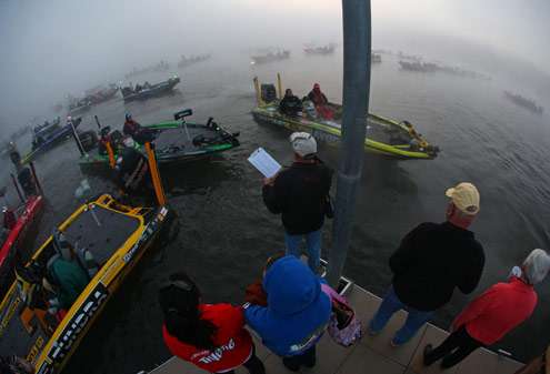 <p>
	Chuck Harbin directs traffic around the take-off area as boats start to line up.</p>
