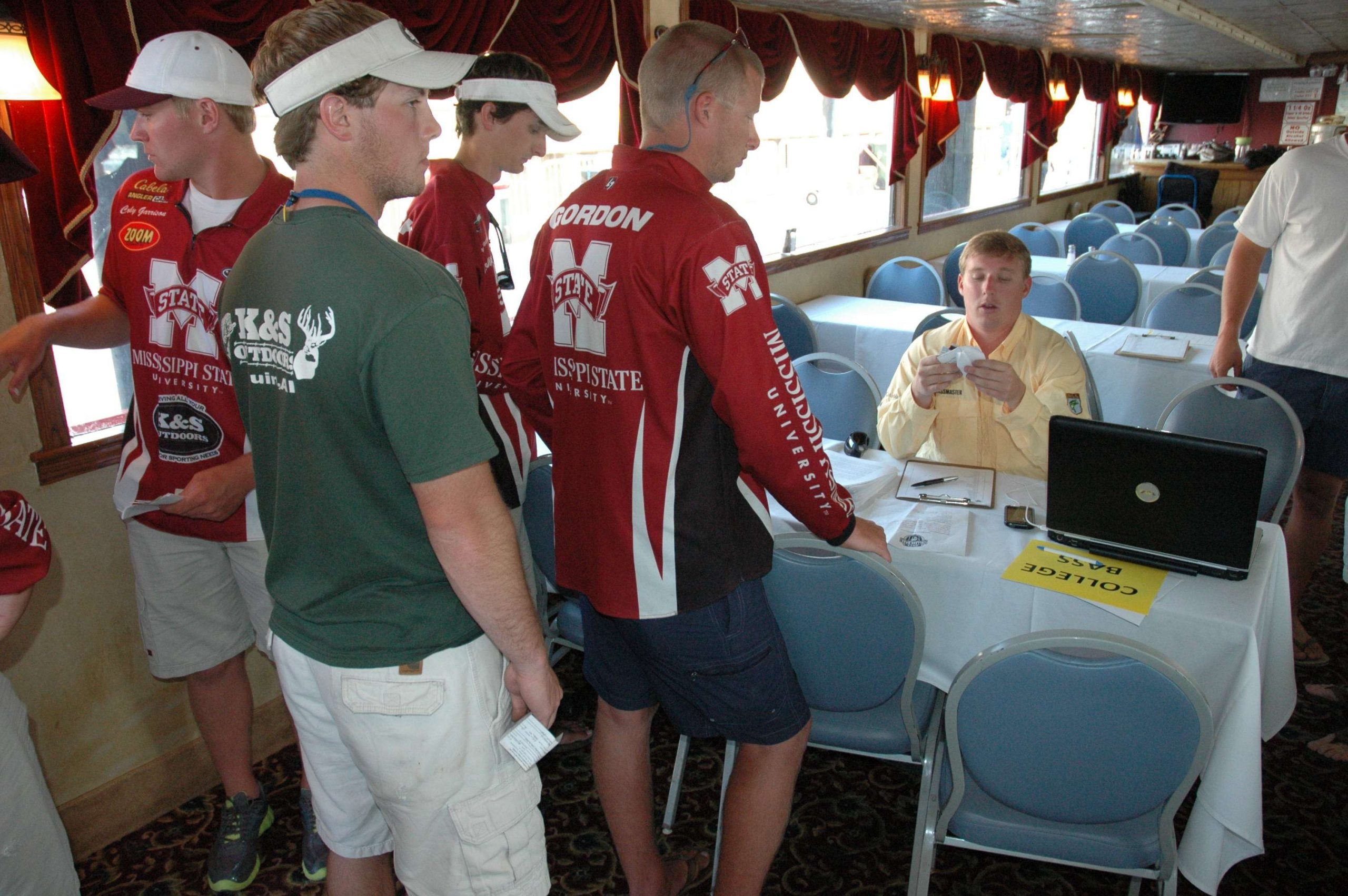 <p>
	Anglers line up to register with Hank Weldon.</p>
