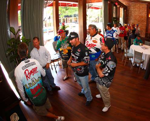 A group of anglers line up to register and show their fishing licenses before the meeting begins.
