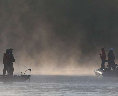 <p>
	A photographer moves in close to get a shot of Paul Elias fishing.</p>
