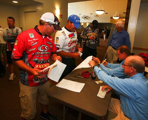 <p> 	Britt Myers and Cliff Crochet show their fishing licenses and get the information sheet for the Evan Williams Bourbon Carolina Clash.</p> 