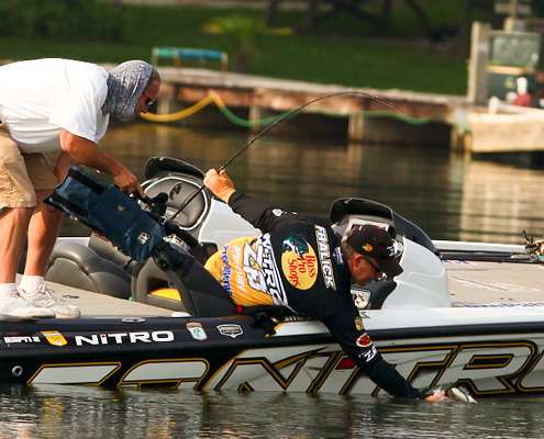 <p>
	Brian Mason captures the action for Bassmaster television as Fralick reaches for the fish.</p>
