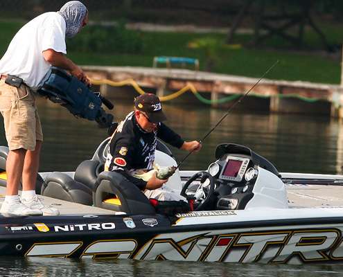 <p>
	Fralick brings his second fish of the morning into the boat.</p>
