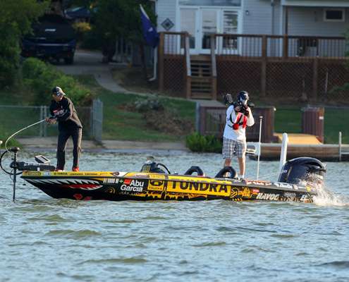 <p>
	The fish makes a jump near the back of the boat as Wes Miller captures the action for Bassmaster television.</p>
