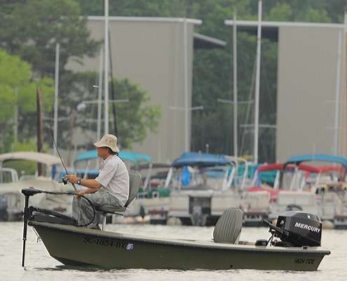 <p>
	A recreational angler fishes within sight of a marina.</p>
