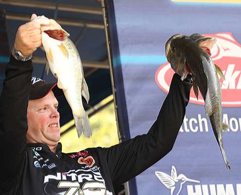 <p>
	Jami Fralick holds up his best two fish after taking the lead on Day One of the Evan Williams Bourbon Carolina Clash.</p>
<p>
	  </p>
