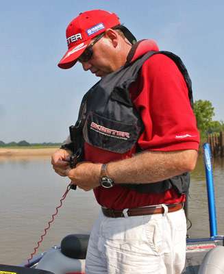 <p>
	Jones connects his PFD before idling out from the area he was fishing.</p>
