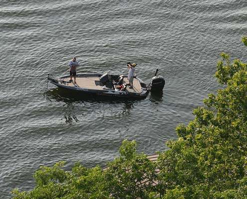 <p>
	About 500 yards away, John Murray fishes a boat dock under shaded by trees.</p>
