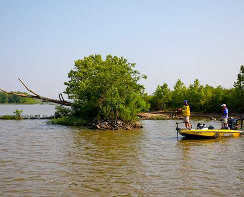 <p>
	 </p>
<p>
	Bobby Lane fishes near a large tree that was deposited on a rock jetty from earlier flooding on the Arkansas River. </p>
