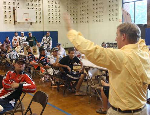 <p>
	 </p>
<p>
	Tournament Director Hank Weldon signals to the crowd before beginning the briefing.</p>
