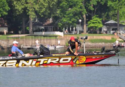 <p>
	Kevin VanDam snags his lure and drops his rod into the water to try to get it free.</p>
