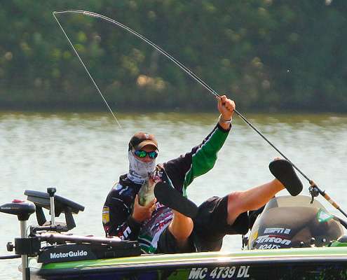 <p>
	Using his legs as leverage, VanDam pulls himself up, fish in hand. </p>
