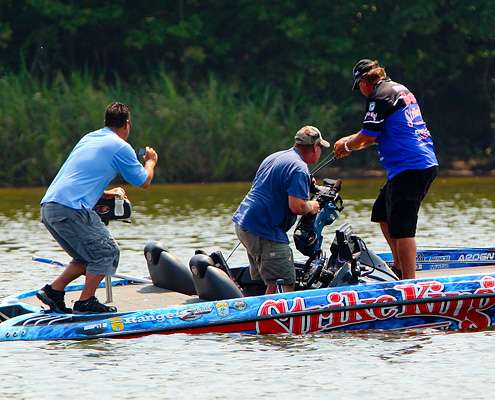 <p>
	Brauer fights his first fish of the day while Mark Zona and Rick Mason shoot video for Bassmaster television and Bassmaster.com. </p>
