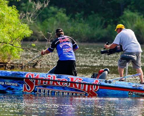 <p>
	Brauer fights his best fish of the day to the boat, while cameraman Rick Mason moves in to capture video for Bassmaster television. </p>
