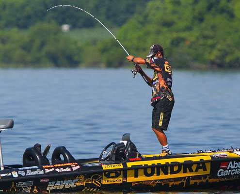 <p>
	Mike Iaconelli eases a fish over the side of the boat. </p>
