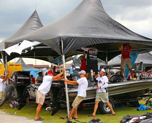 <p>
	 </p>
<p>
	Boyd Duckett and Gary Klein, along with several spectators help hold a tent down as strong winds hit the weigh in site at Lake Wheeler. </p>
