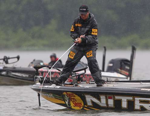 <p>
	Timmy Horton hooks into a big bass as Clark Reehm idles by.</p>

