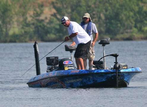 <p>
	Tournament leader Denny Brauer hooks up with a good-sized fish on Friday.</p>
