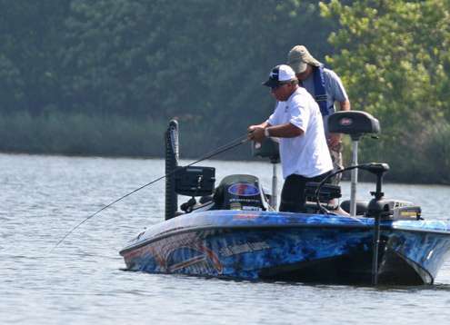 <p>
	Denny Brauer plays a big fish to the boat on Friday.</p>
