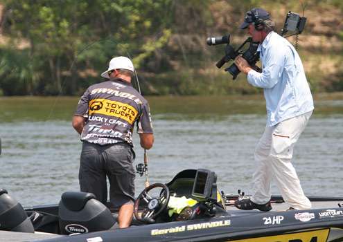 <p>
	With the big fish close to the boat, Gerald Swindle moves back to land it as an ESPN camera films the action.</p>
