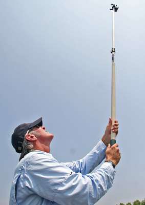 <p>
	Cameraman Wes Miller uses an extending pole to get some high shots of Gerald Swindle fishing.</p>
