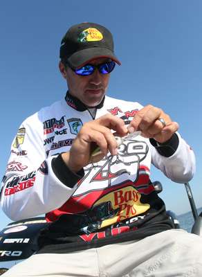 <p>
	After hooking a bunch of white bass, Edwin Evers reties and changes out the hooks.</p>
