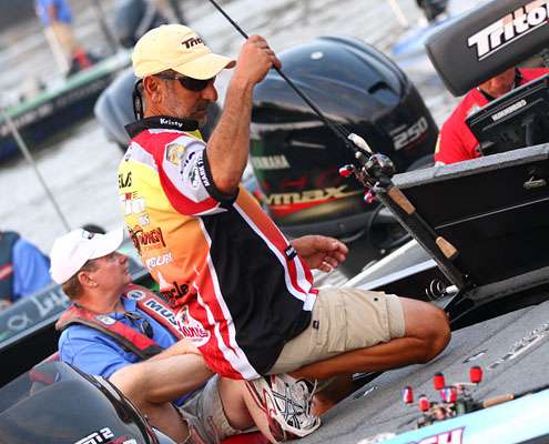 <p>
	Paul Elias moves his rods from his locker to the deck of his boat.</p>
