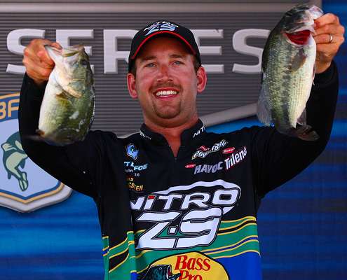 <p>
	Ott DeFoe proudly hold up two of his 5 fish limit on day four of the 2011 Dixie Duel. </p>
