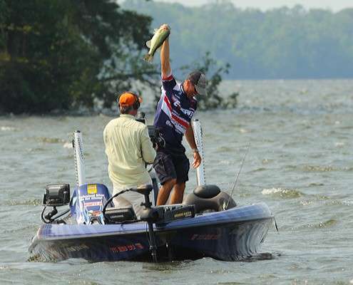 <p>
	Walker holds a big bass high as he closes out Day Four.</p>
