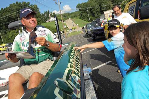<p> 	Davy Hite signs an autograph in the book published for Toyota Trucks All-Star Week.</p> 