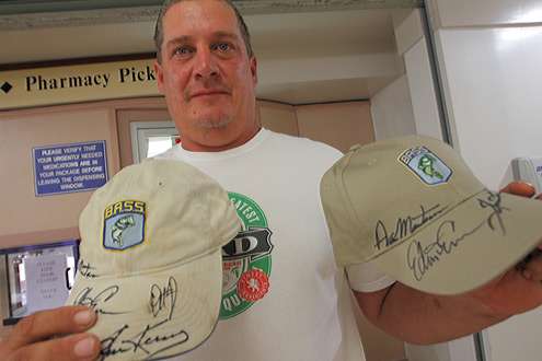 <p>
	 </p>
<p>
	A fishing fan shows off the hats and autographs he got Thursday morning.</p>
