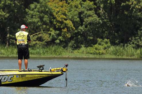 <p>
	A bass tries to jump free as Skeet Reese reels it carefully to the boat.</p>
