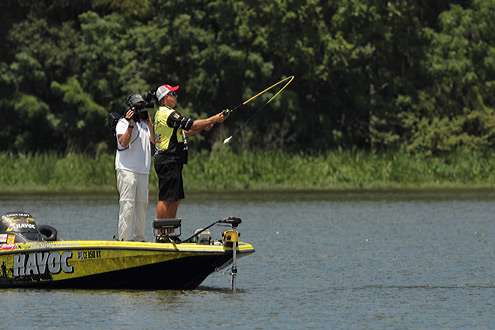 <p>
	 </p>
<p>
	His rod loads up under the weight of his crankbait as Skeet Reese makes another cast.</p>

