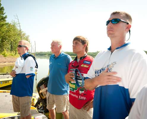 <p>
	Elite angler Keith Poche salutes the flag during the national anthem.</p>
