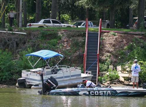 <p>
	 </p>
<p>
	Casey Ashley works a pontoon as a sheriff watches from shore.</p>
