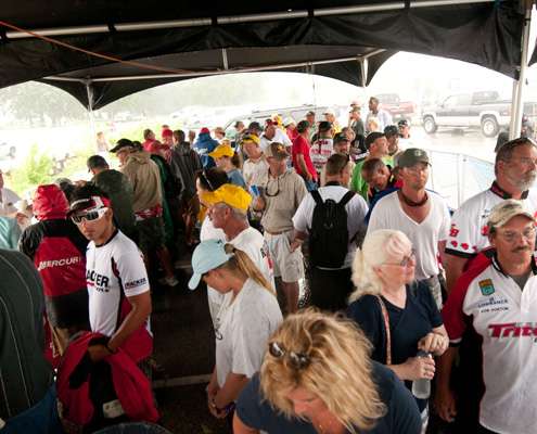 Competitors and their families hid from the weather under the tent.
