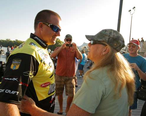 <p>
	Skeet Reese chats with a fan at the dock.</p>
