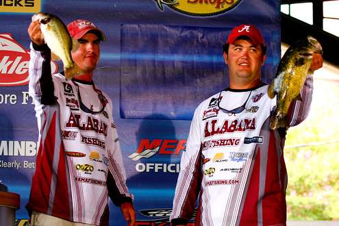 <p>
	The Alabama team of Christian and Johnson hold up their biggest bass.</p>
