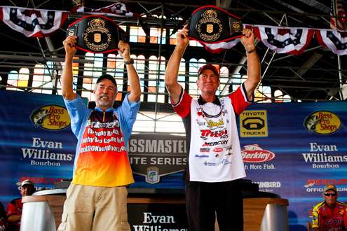 <p>
	Eaker and Cook hold their championship belts high. </p>
