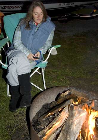 Valerie enjoys a welcome campfire.</p>
