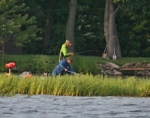 <p>
	Fukae fights the bass as his non-boater scoops it into the net.</p>
