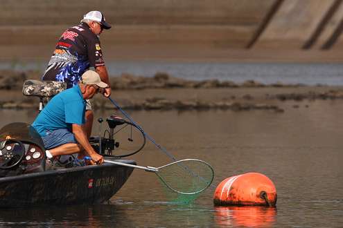 <p>
	Biffle calls for the net as he pulls a fish to the boat. </p>
