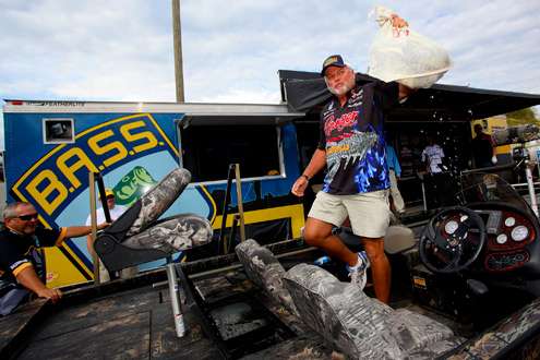 <p> 	 </p> <p> 	Biffle lifts his winning bag of fish into the air. </p> 