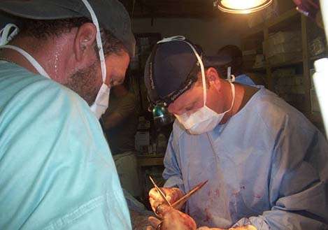 <p>
	 </p>
<p>
	Mac performing surgery with Brian Eastridge in the goat barn.</p>
